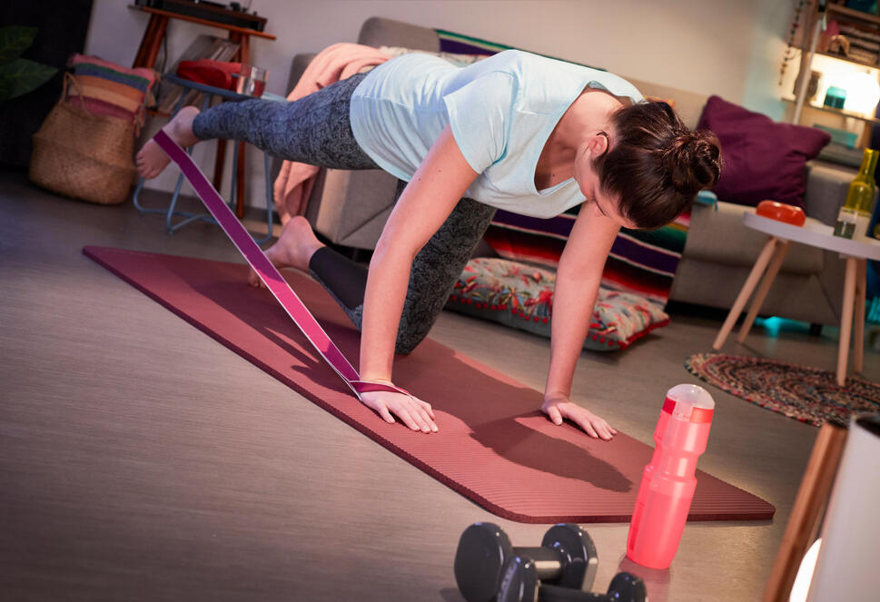 Woman doing pilates on a mat at home