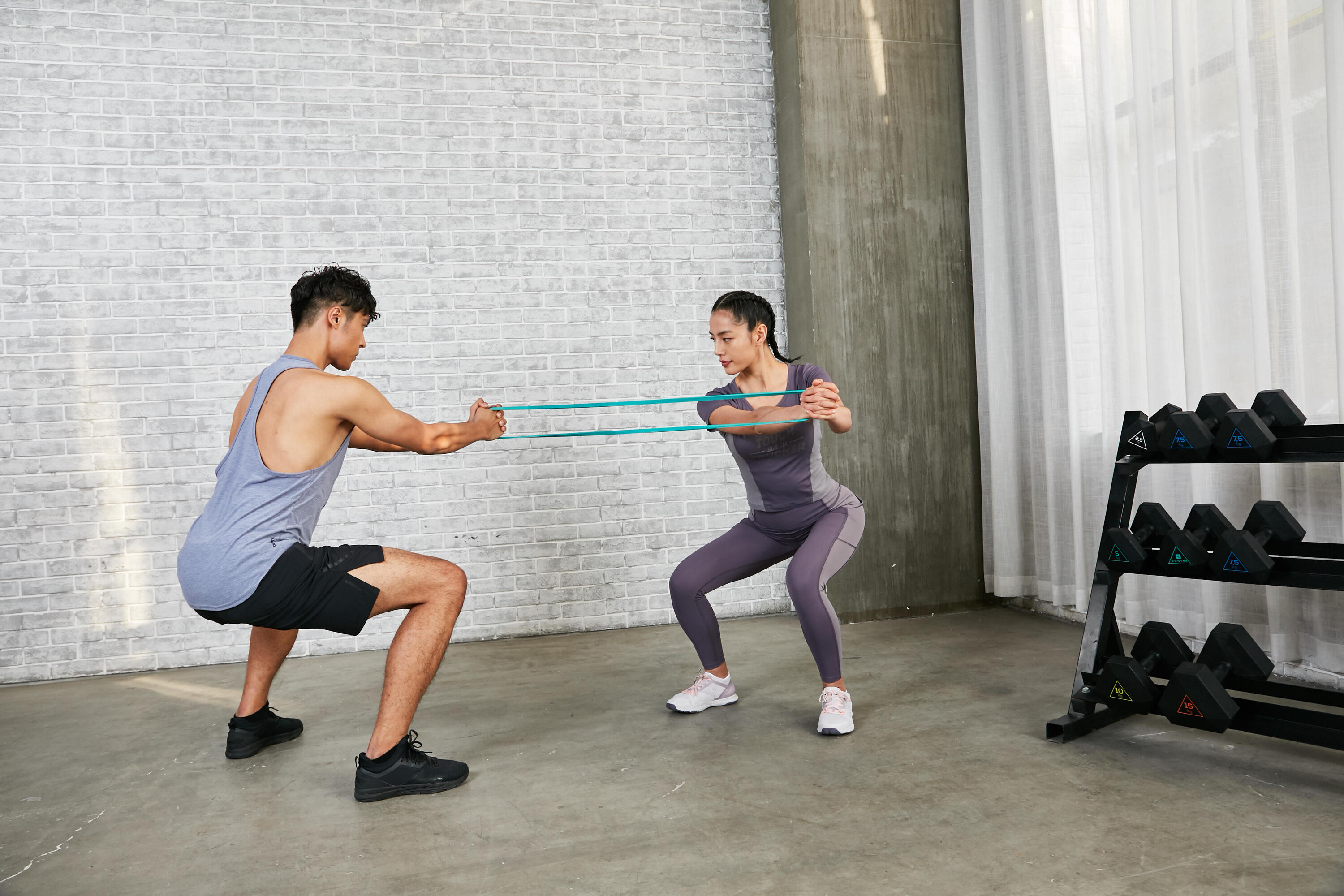 Man and woman exercising with resistance bands