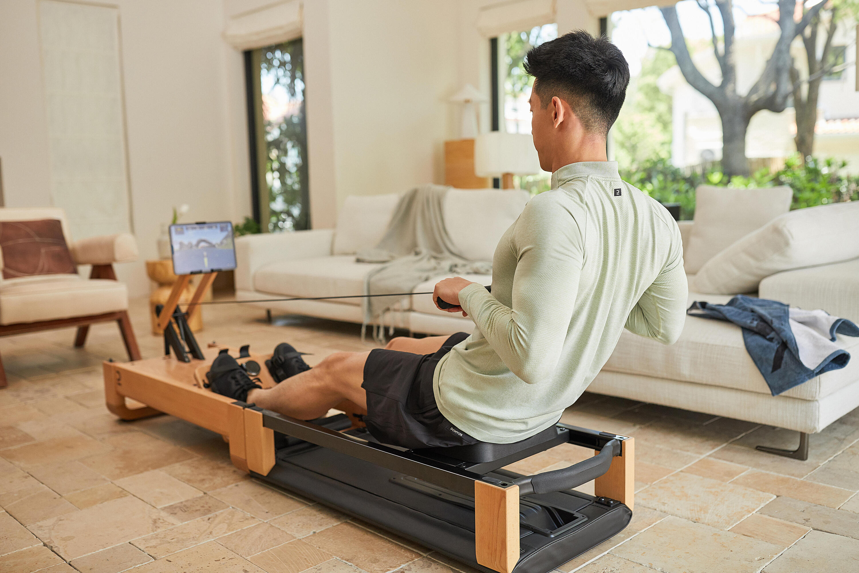 Person training on a rowing machine at home