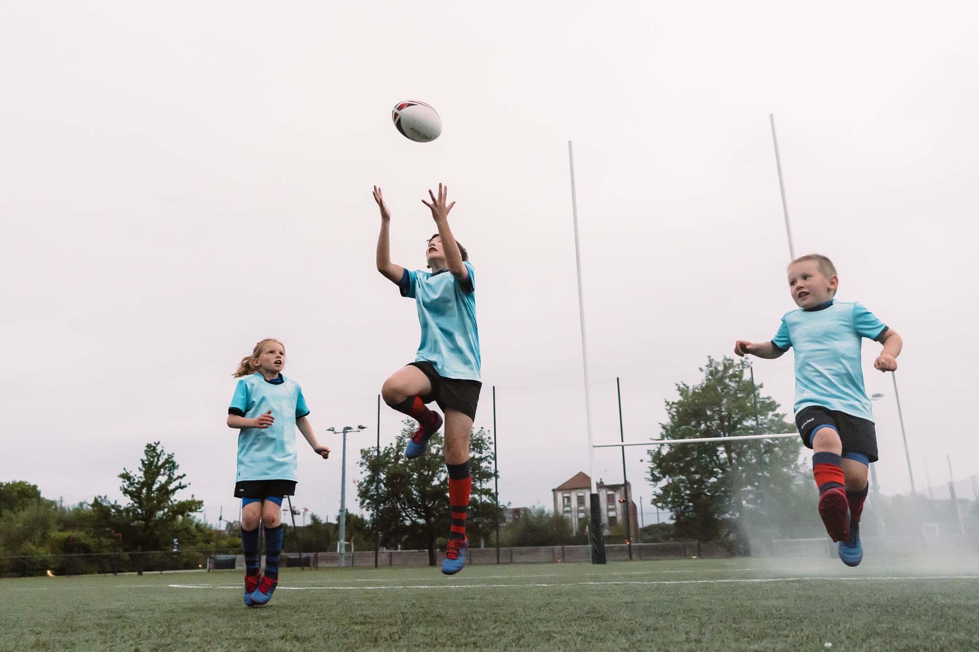 Player kicking an AFL ball on an oval