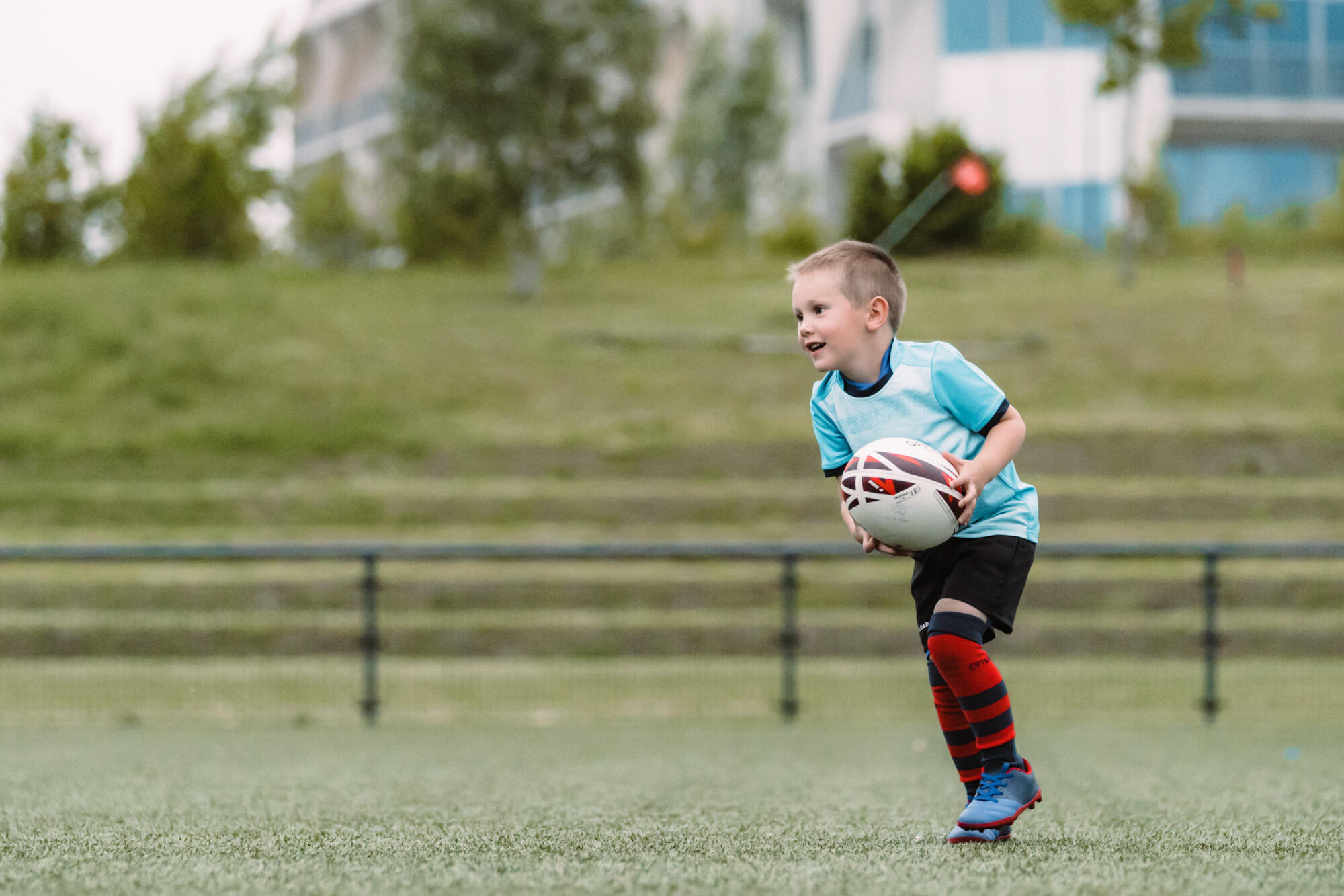 AFL ball held ready for a kick