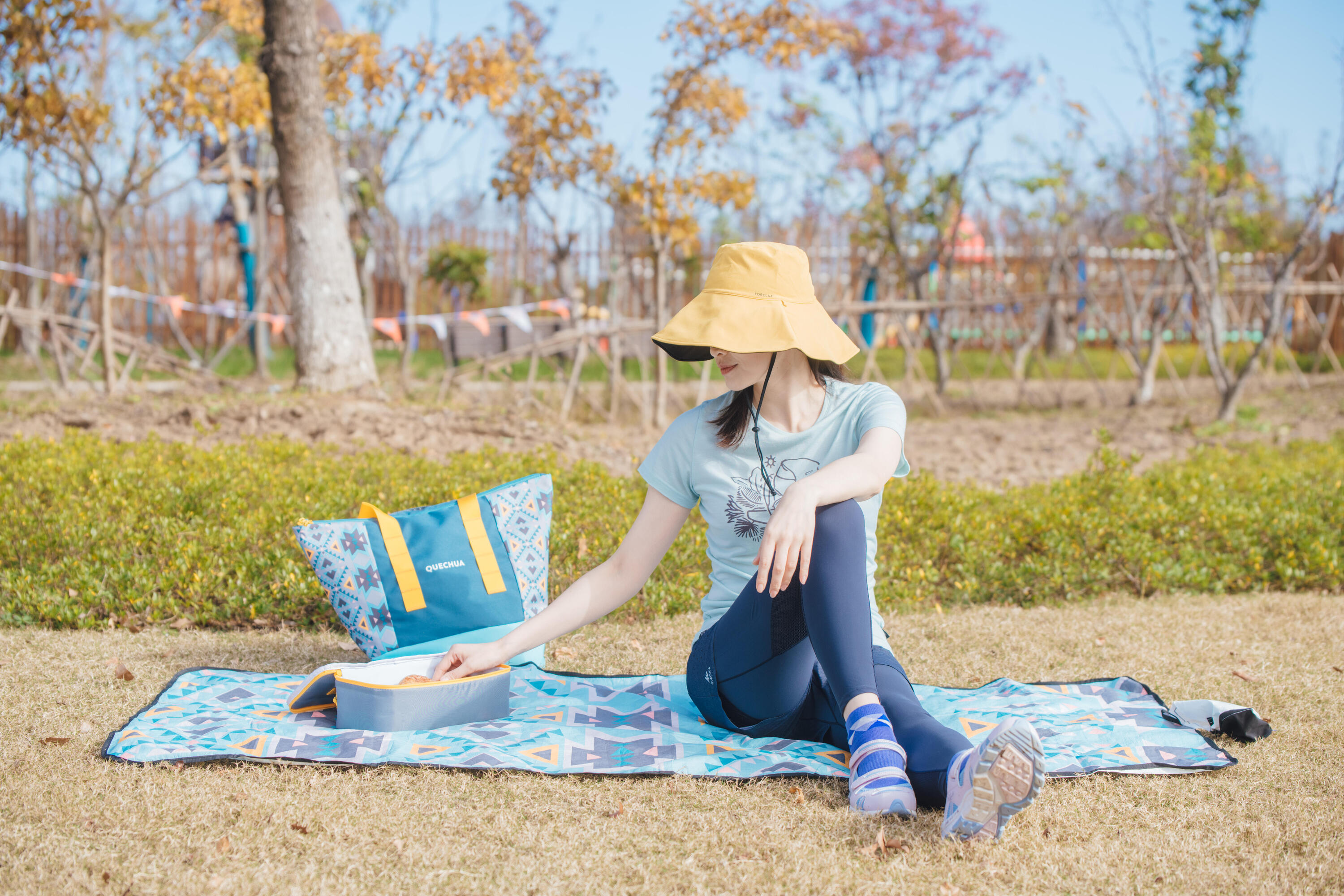 Family relaxing on a picnic blanket outdoors