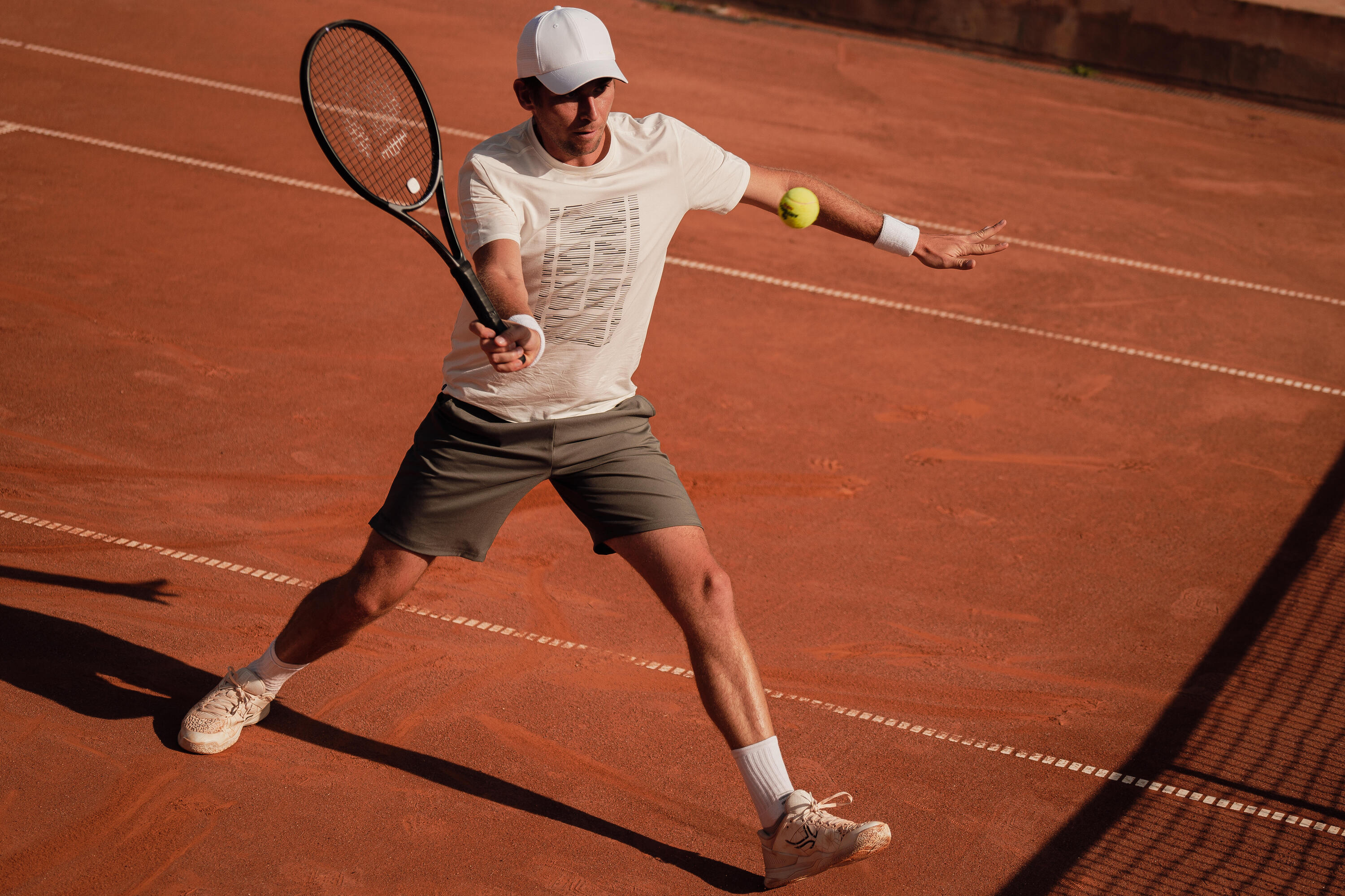 Tennis shoes beside tennis balls on a court