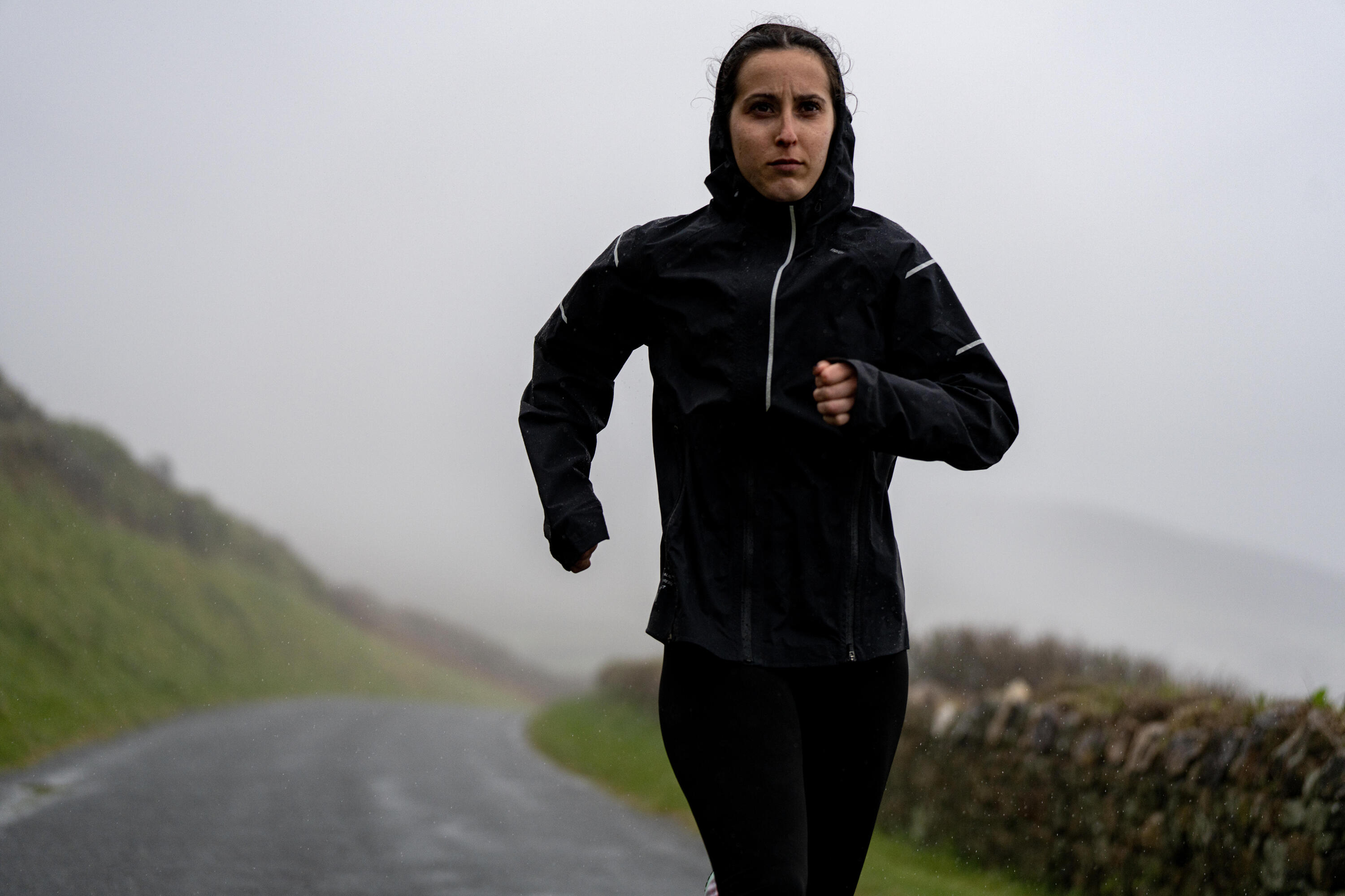 Person wearing a rain jacket in wet weather